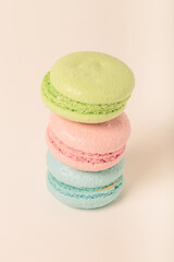 Colorful cake macaroons on a light background. Toned