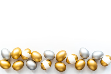 Silver and golden eggs isolated on white background. Easter decoration background. Top view