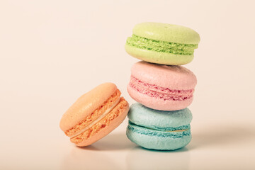 Colorful cake macaroons on a light background. Toned
