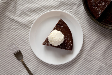 Homemade Chocolate Cake with Ice Cream on a white plate, top view. Flat lay, overhead, from above.