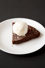 Homemade Chocolate Cake with Ice Cream on a black background, low angle view.