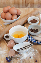 Top View Baking Preparation on wooden Table,Baking ingredients. Bowl, eggs and flour, rolling pin and eggshells on wooden board,Baking concept