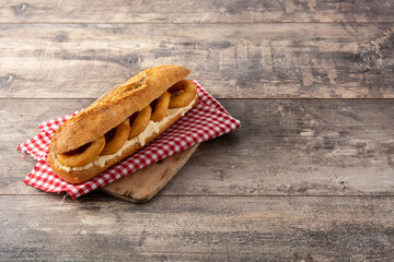 Calamari rings sandwich on wooden table, typical food from Madrid