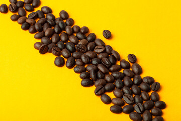 Roasted coffee beans on the color background for wallpaper or decor