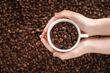 Сoffee beans in hand. View from above