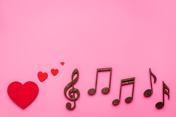 Love songs - musical wooden notes with heart, top view