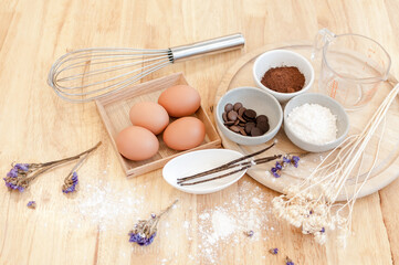 Fototapeta na wymiar Top View Baking Preparation on wooden Table,Baking ingredients. Bowl, eggs and flour, rolling pin and eggshells on wooden board,Baking concept