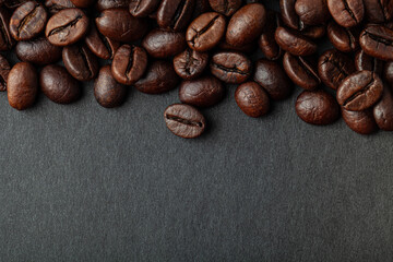 Roasted coffee beans on the black background for wallpaper or decor