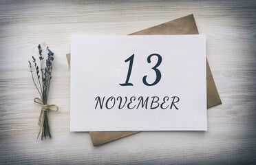 november 13. 13th day of the month, calendar date.White blank of paper with a brown envelope, dry bouquet of lavender flowers on a wooden background. Autumn month, day of the year concept