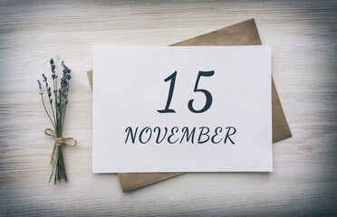november 15. 15th day of the month, calendar date.White blank of paper with a brown envelope, dry bouquet of lavender flowers on a wooden background. Autumn month, day of the year concept