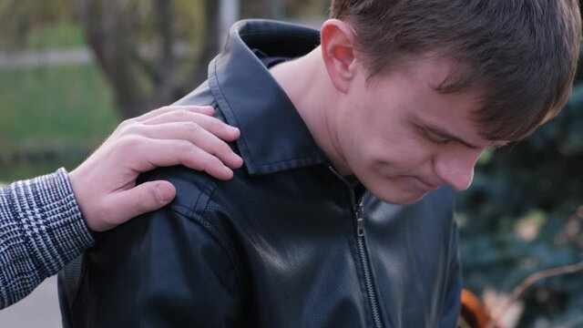 Consolation And Compassion. Friend Tapping On The Shoulder Of A Man As A Sign Of Support, Close-up