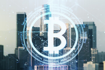 Virtual Bitcoin hologram on Los Angeles skyline background. Multiexposure