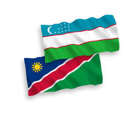 National vector fabric wave flags of Republic of Namibia and Uzbekistan isolated on white background. 1 to 2 proportion.