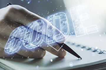Creative Code word sign and man hand writing in notepad on background, international software development concept. Multiexposure
