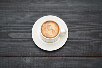Cup of espresso coffee on dark wooden background