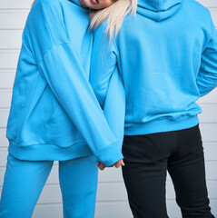 pair of woman and man wear a no logo hoodie. sweatshirt design template. copy space street wear clothing