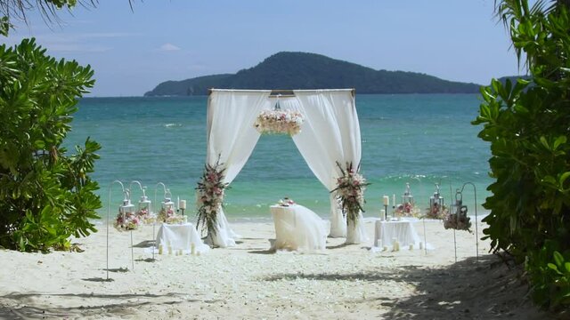 Beautiful wedding Island arch with lots of flowers on the beach with white sand  At Phuket , Thiland. 