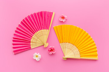 Top view of two hand fans made of bamboo and paper