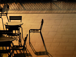 table and chair on the floor in the restaurant with sunlight and shadow at sunset