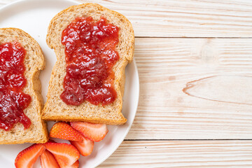 whole wheat bread with strawberry jam and fresh strawberry