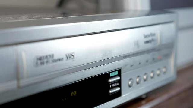 Old appliances,  loading a video tape in a vhs player