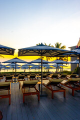 umbrella and chair around outdoor swimming pool in hotel resort for holiday vacation travel background