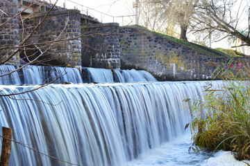 river dam. water release, The excess capacity of the dam until spring-way overflows. streams of water, stone walls, a large construction of a dam on a reservoir. water being released from a dam.