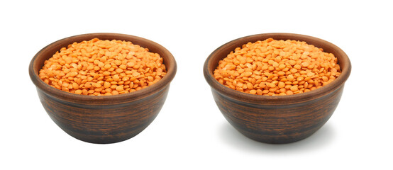 red lentils in clay bowl on white background, isolated and with shadow