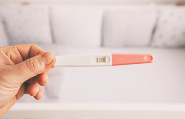 The woman holds the pregnancy test