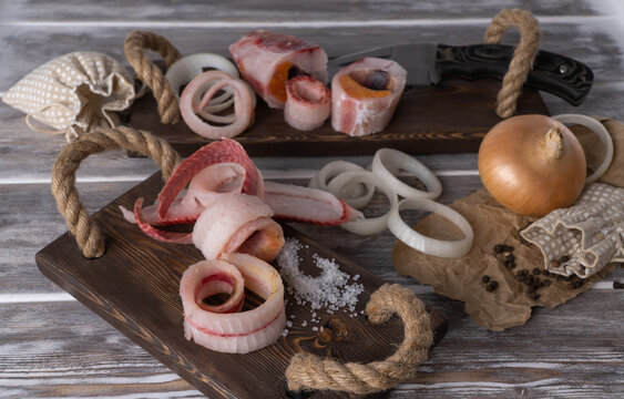 sliced frozen fish. selective focus. raw frozen fish cut into shavings on a wooden background. Stroganina, one of the main dishes of northern cuisine. Planked fish.