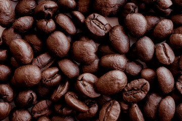 Coffee beans. Coffee beans are spread out on the surface.