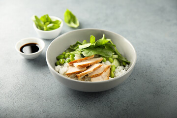 Healthy rice bowl with chicken and spinach