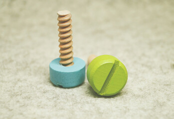 wooden screws on a beige background children's toy decor item repair detail tool ecological material 