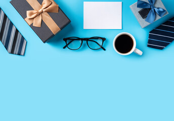 Father's Day gift. Top view design concept of holiday greeting idea with card on blue background.