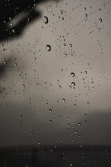 Fototapeta na wymiar Raindrops beading on a window or windscreen