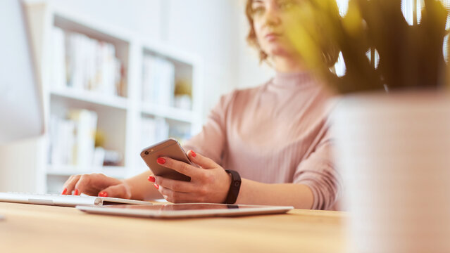 Happy Woman Working Using Multiple Devices On A Desk At Home