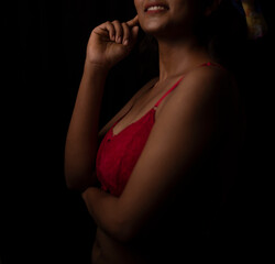 Portrait of an young and attractive Bengali Indian brunette girl wearing red lingerie posing in...