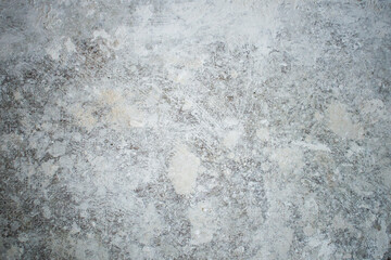 White dirty dusty plain floor surface in a renovated building covered with dust from grinding and painting the walls. White dirty monochrome background.