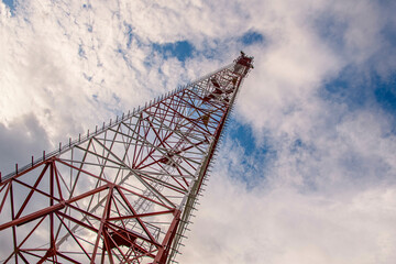 Cell phone tower, communications tower with blue cloud sky background