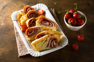 Fototapeta na wymiar Homemade strawberry vanilla pastry roll