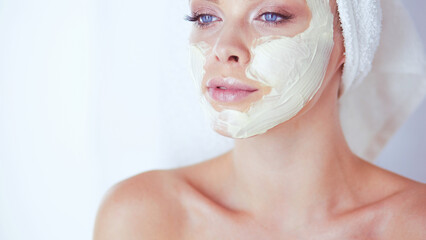 A picture of a young woman applying face powder in the bathroom