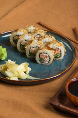 Top view of delicious sushi rolls with ingredients on wooden table. Sushi menu. Japanese kitchen, restaurant.