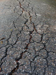 close up crack wet asphalt road after rain