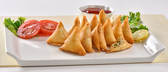 Chicken and Vegetable Samosa, Pakistan and India's most eating snack. Triangle Shape Crunchy Wraps and stuffed with vegetables and chicken.