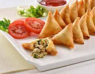 Chicken and Vegetable Samosa, Pakistan and India's most eating snack. Triangle Shape Crunchy Wraps and stuffed with vegetables and chicken.