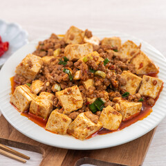 Mapo tofu. Stir-fried tofu with hot spicy sauce in white plate.