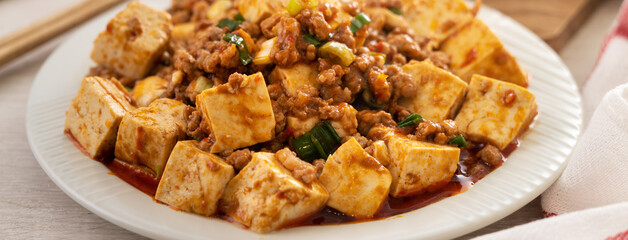 Mapo tofu. Stir-fried tofu with hot spicy sauce in white plate.