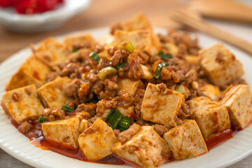 Mapo tofu. Stir-fried tofu with hot spicy sauce in white plate.