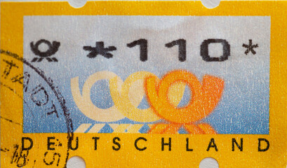 GERMANY - CIRCA 2002 : a postage stamp from Germany, showing a machine postage stamp post emblems three post horns, issue for the Federal Republic