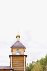 wooden temple, a temple made of logs, an Orthodox church, a Christian church, a dome of a church 